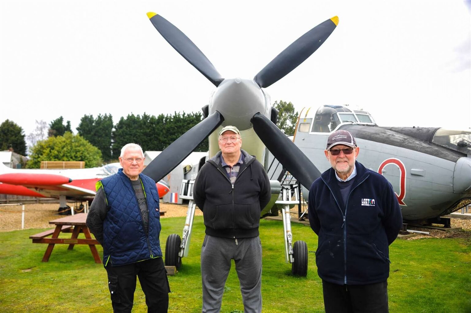 Men in front of plane