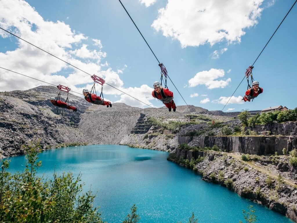 4 friends on a zip line over a quarry