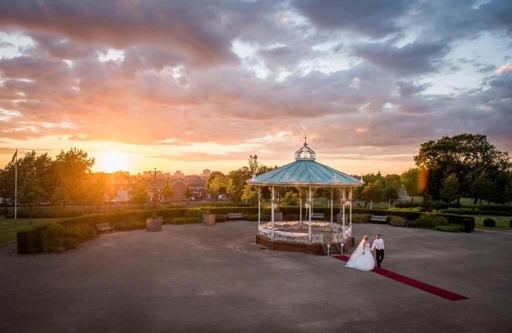 Couple walking away from Gazebo on wedding day.