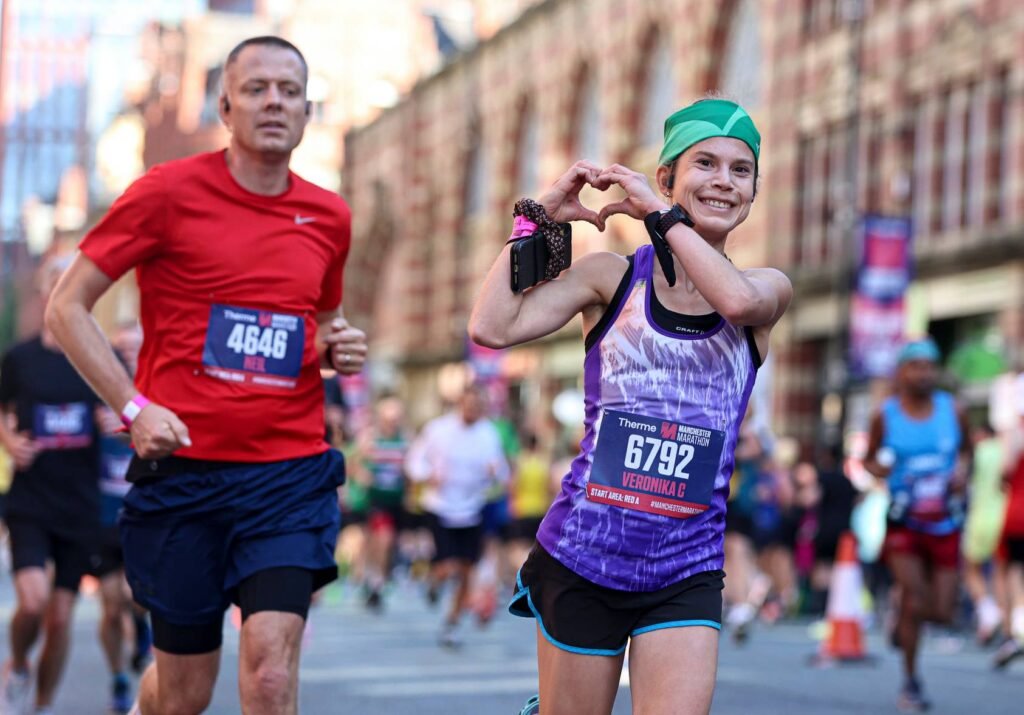 Man and woman running Manchester Marathon